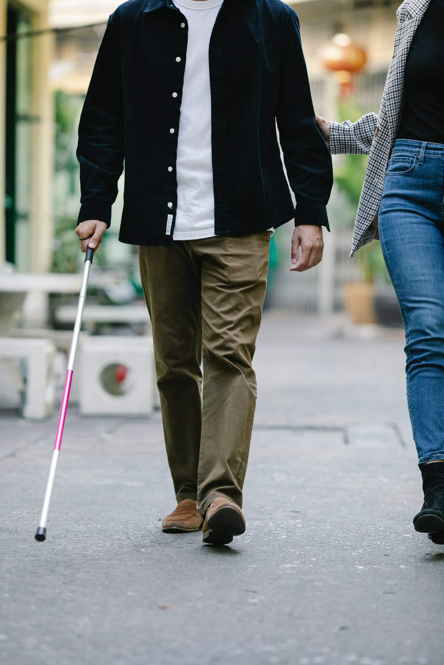 Man walking with a white cane