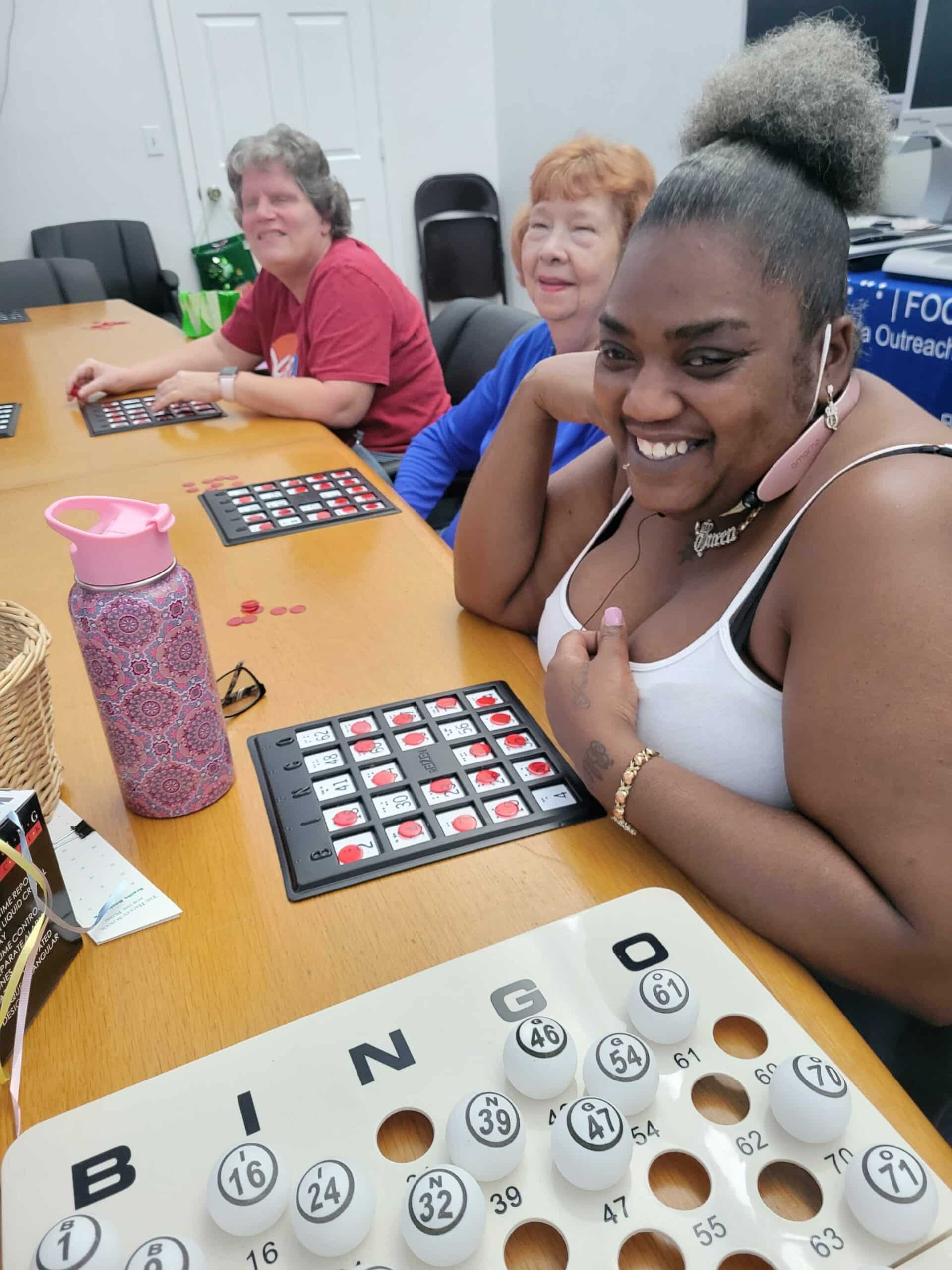 Three happy women with their bingo cards