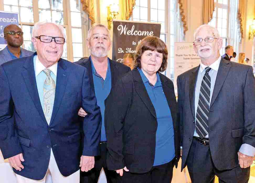 Carolyn Lapp posing for photo with three men