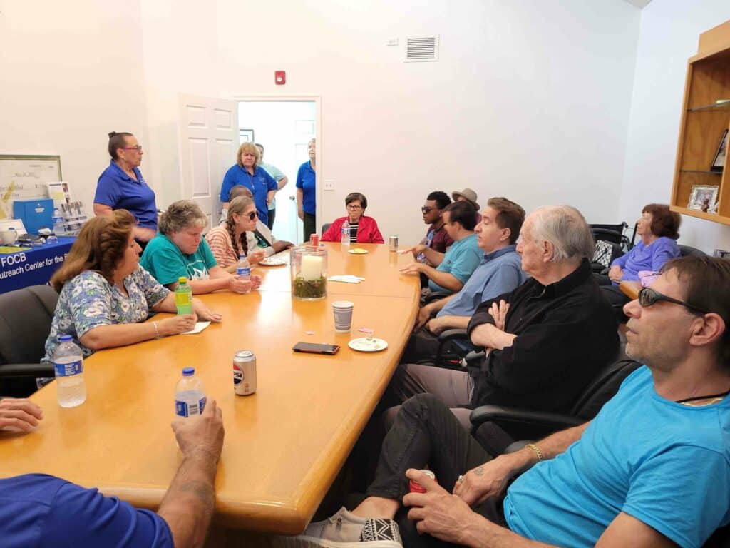 Group of adults sit around a large table