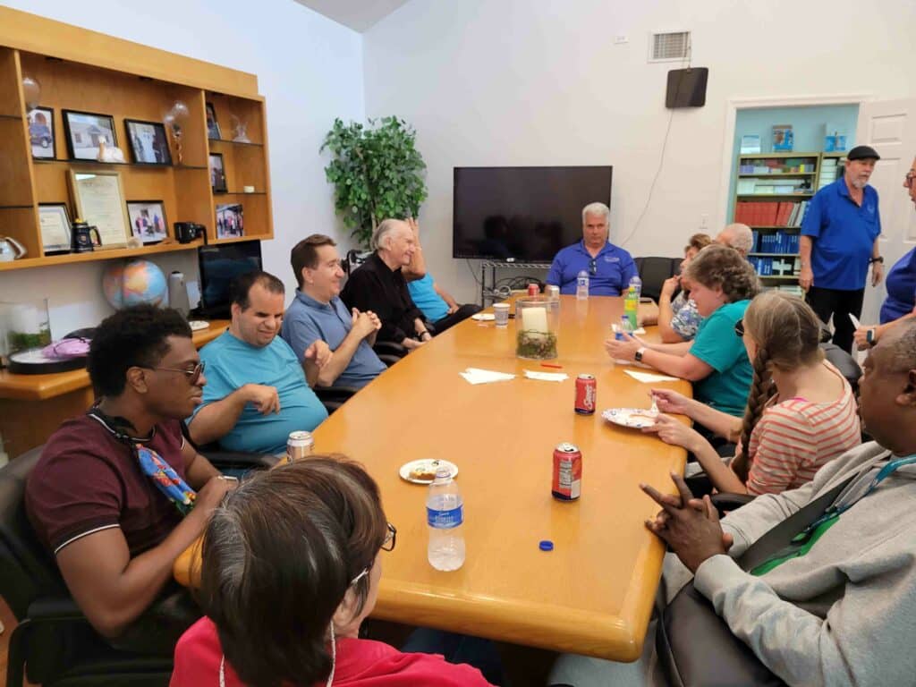 Group of adults sit around a large table