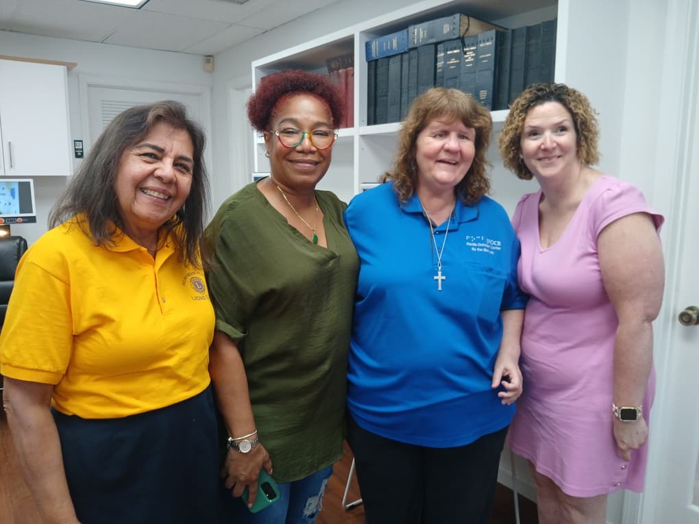 four women smiling at camera
