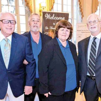 Carolyn Lapp posing for photo with three men