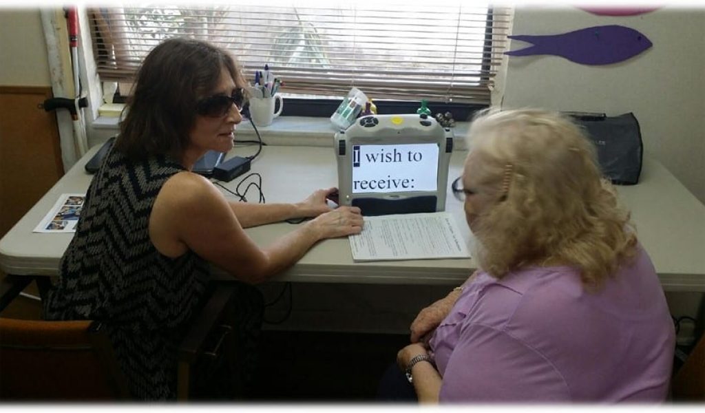 Client learning to use visual aids with the help of a trainer