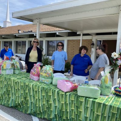 Volunteers handing out gift baskets at an event