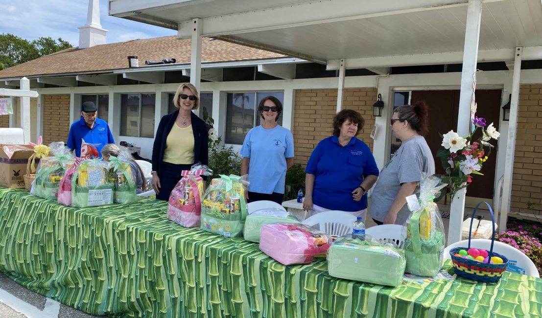 Volunteers handing out gift baskets at an event